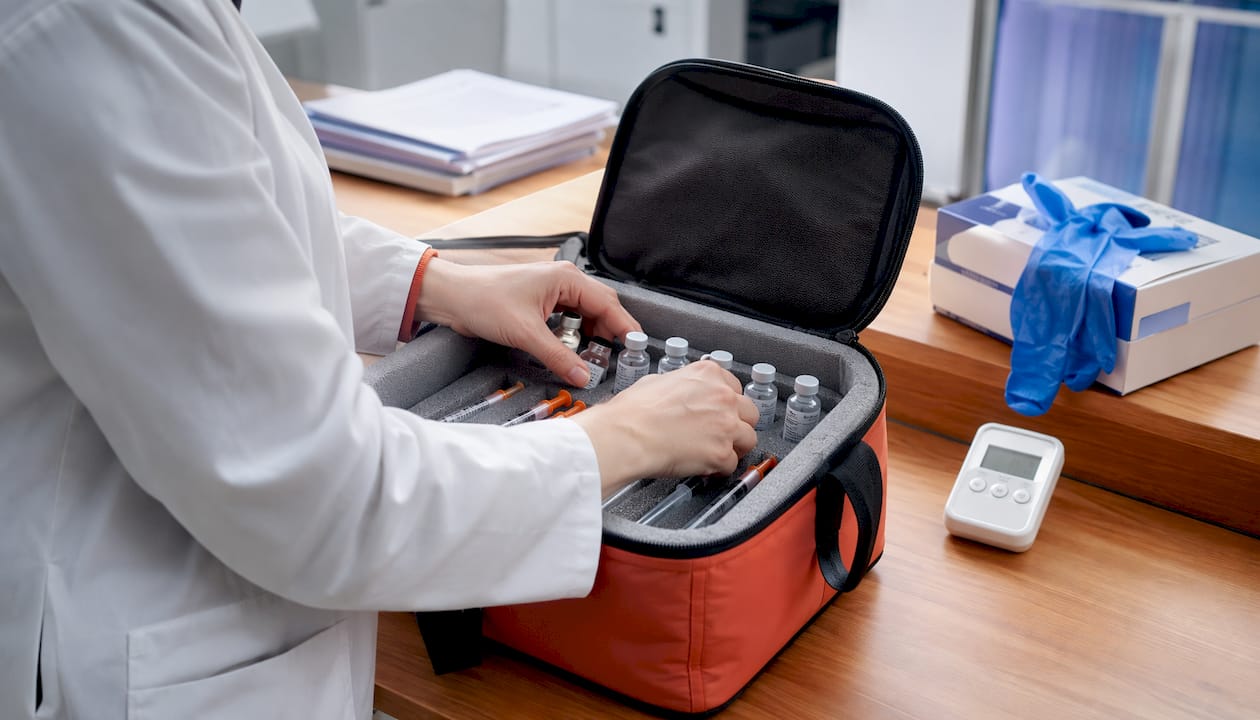 Hands-packing-clinical-trial-medication-delivery-box - lyv