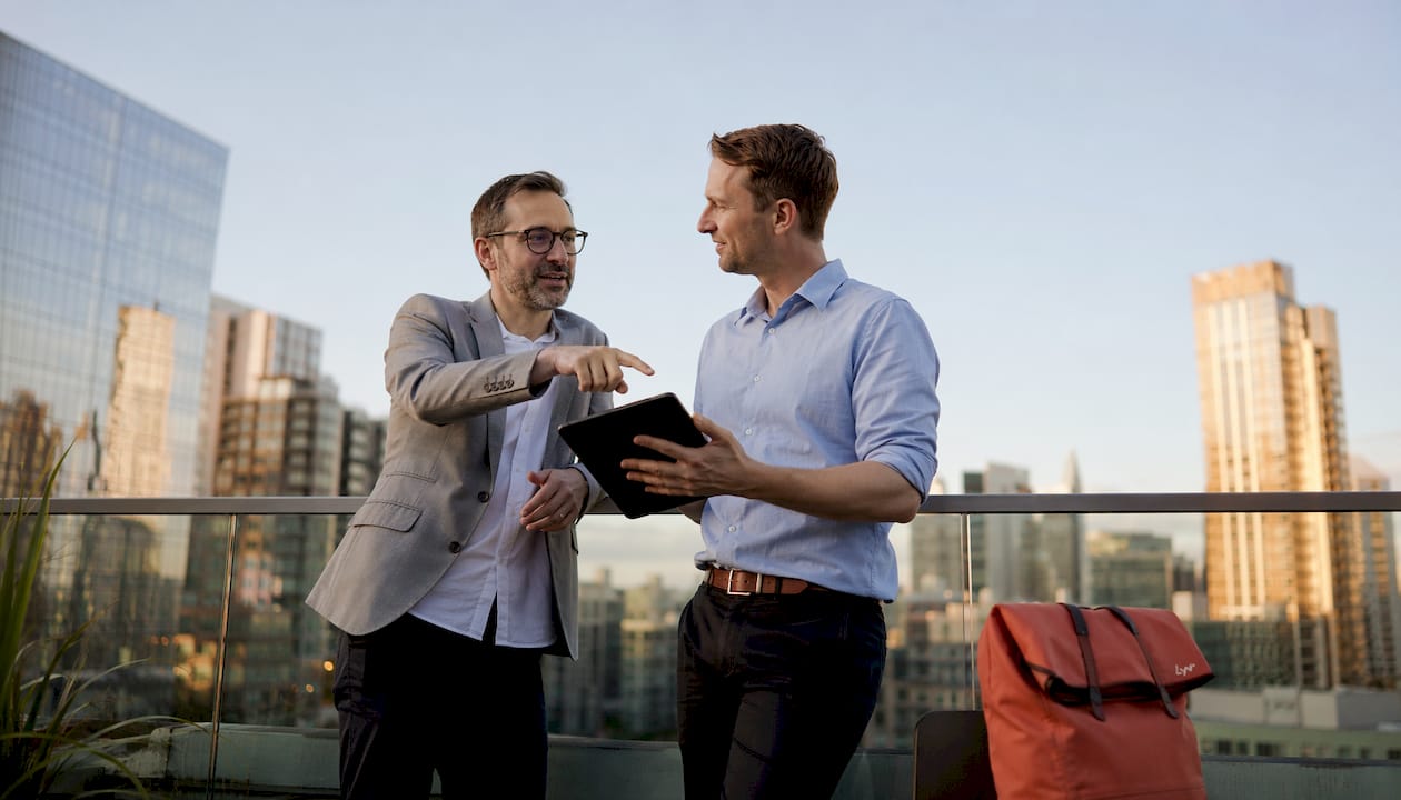 Two-professionals-discussing-DTP-model-outdoors - lyv